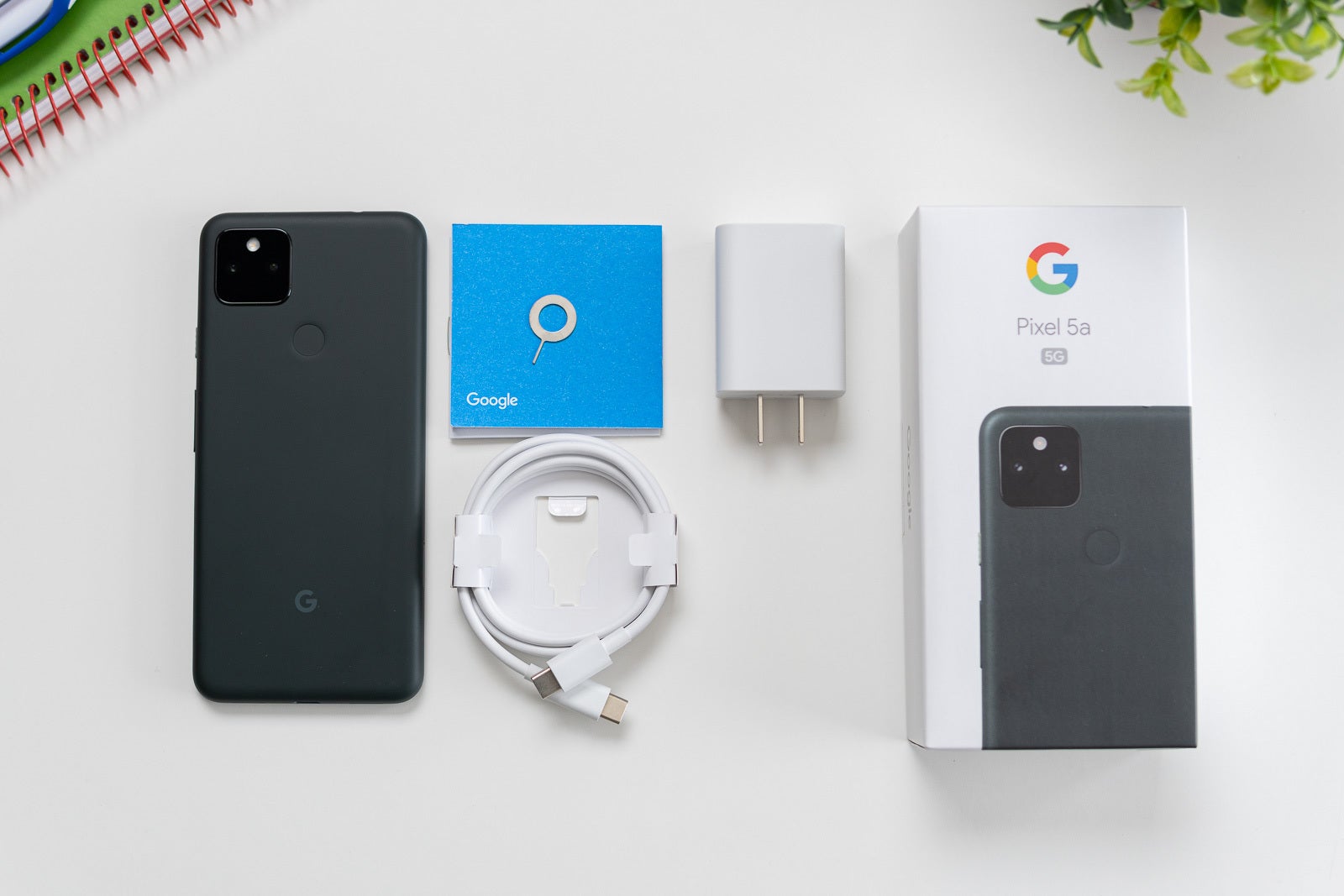 You'll find a charger and a type C cable in the box. You also get a type C to standard USB adapter, and a SIM tool (but there is no case included) - Google Pixel 5a Review: Boring looks hide an outstanding budget phone