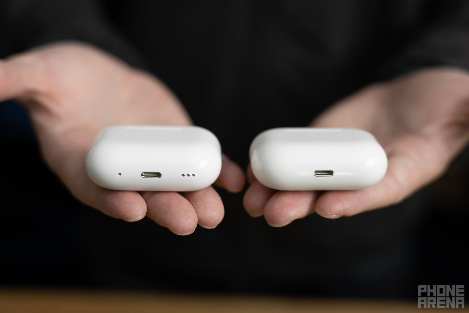 AirPods Pro 2 (left, note the new speaker grill next to the charging port) vs AirPods Pro (right) - AirPods Pro 2 vs AirPods Pro comparison: What&#039;s different?