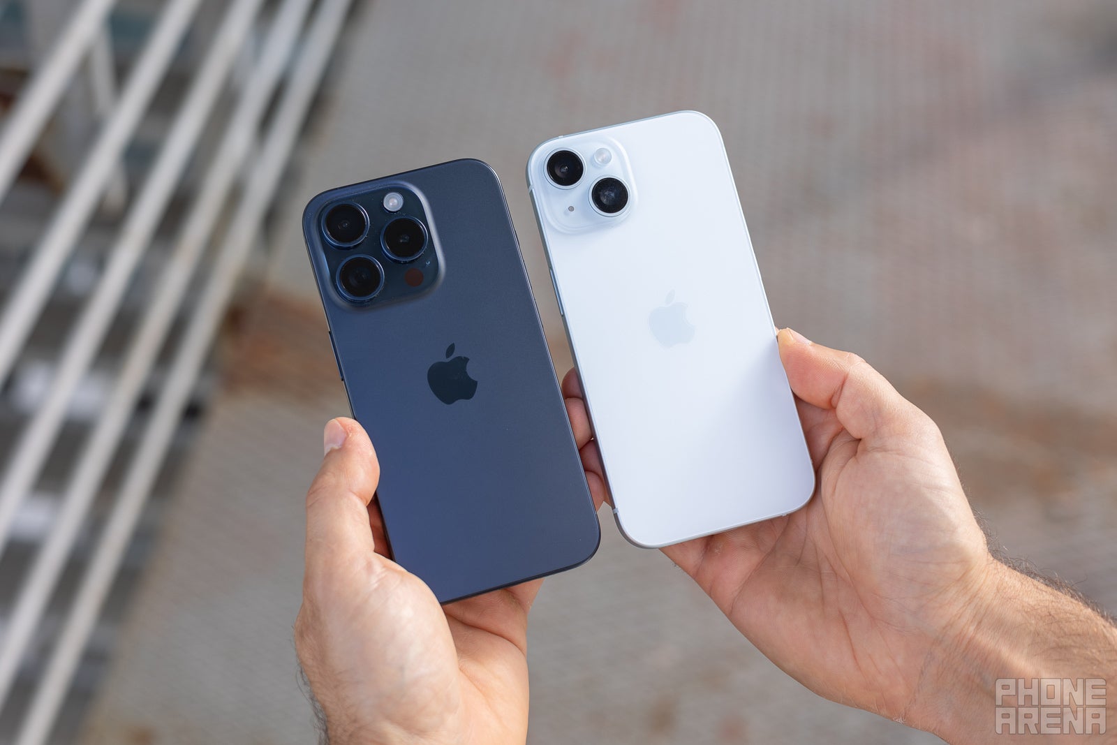 iPhone 15 and iPhone 15 Pro held in hand