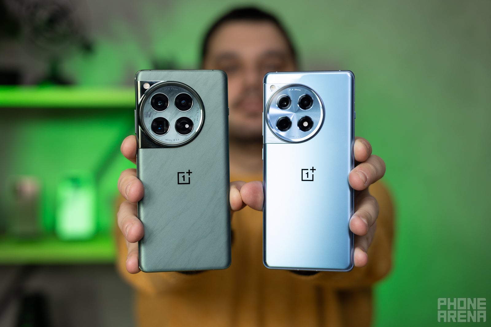 A person holding the OnePlus 12 and OnePlus 12R