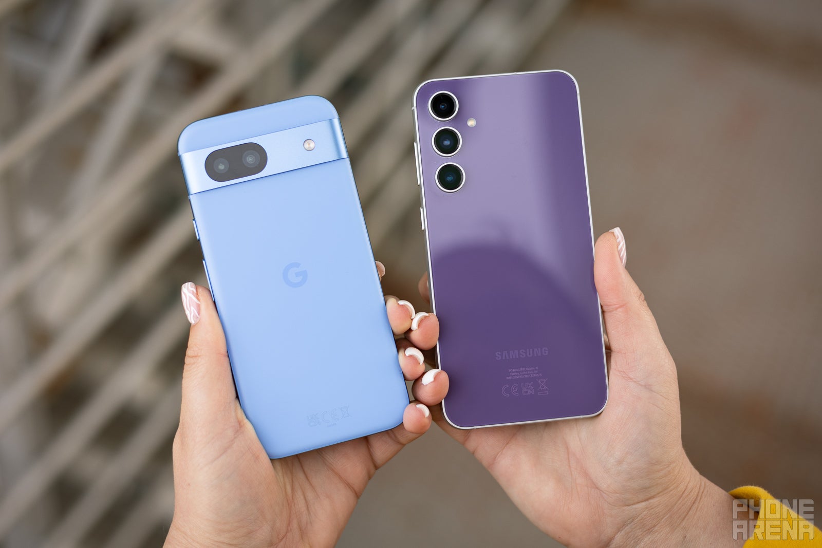 Pixel 8a has a matte plastic back vs the glossy glass one of the Galaxy S23 FE. (Image by PhoneArena) - Google Pixel 8a vs Samsung Galaxy S23 FE: Is it worth paying $130 more for the Fan Edition?