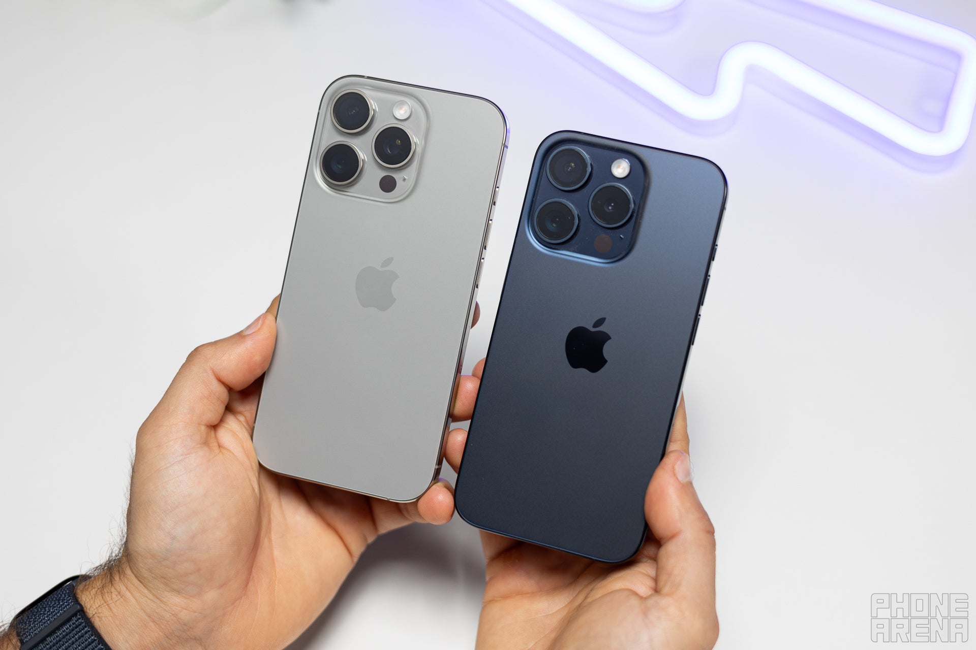 iPhone 16 Pro in Natural Titanium (gray) and 15 Pro on the right in blue (Image by PhoneArena) - iPhone 16 Pro vs iPhone 15 Pro: What are the differences?