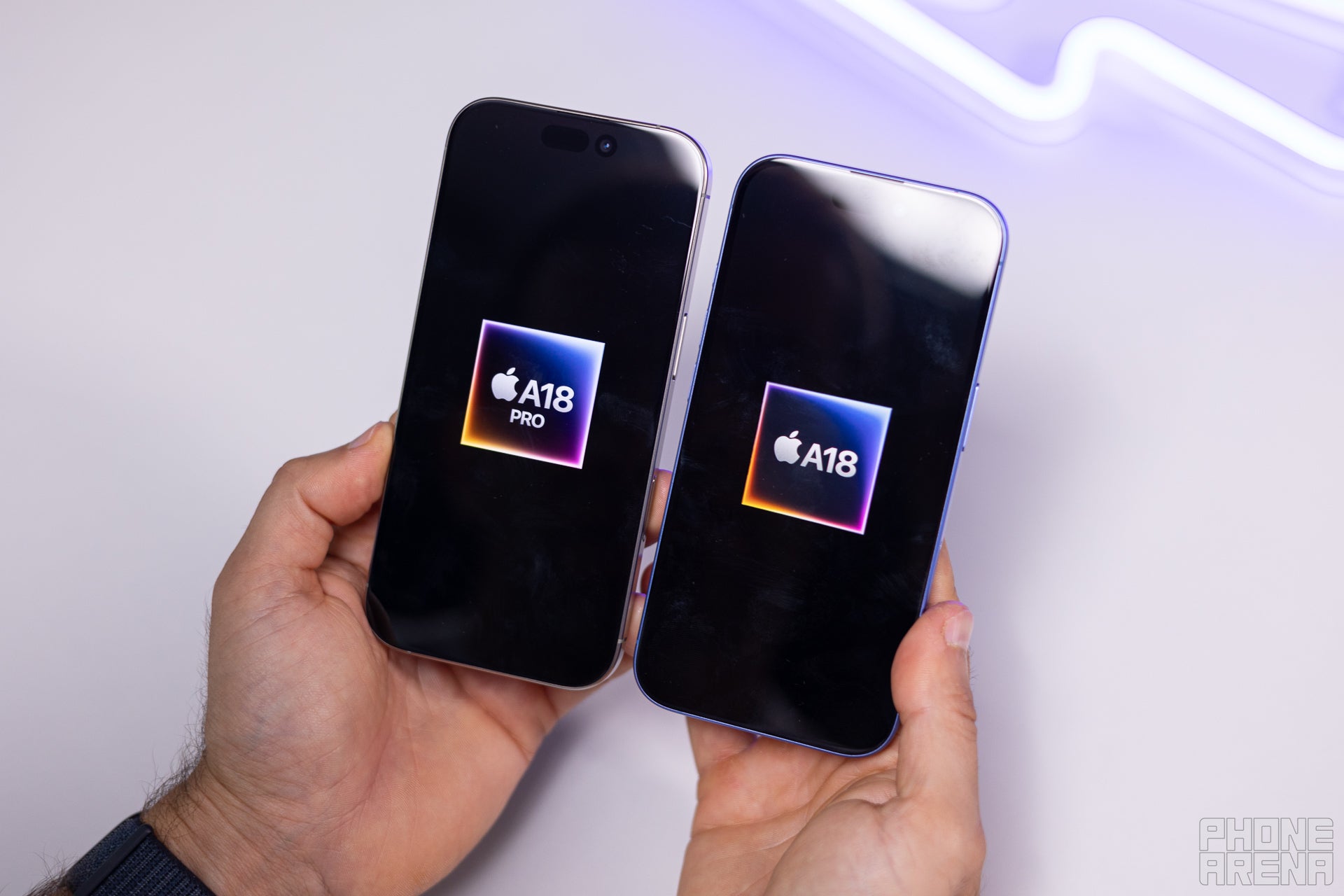 A picture of the iPhone 16 Pro next to the iPhone 16 with their displays showing the CPUs powering them