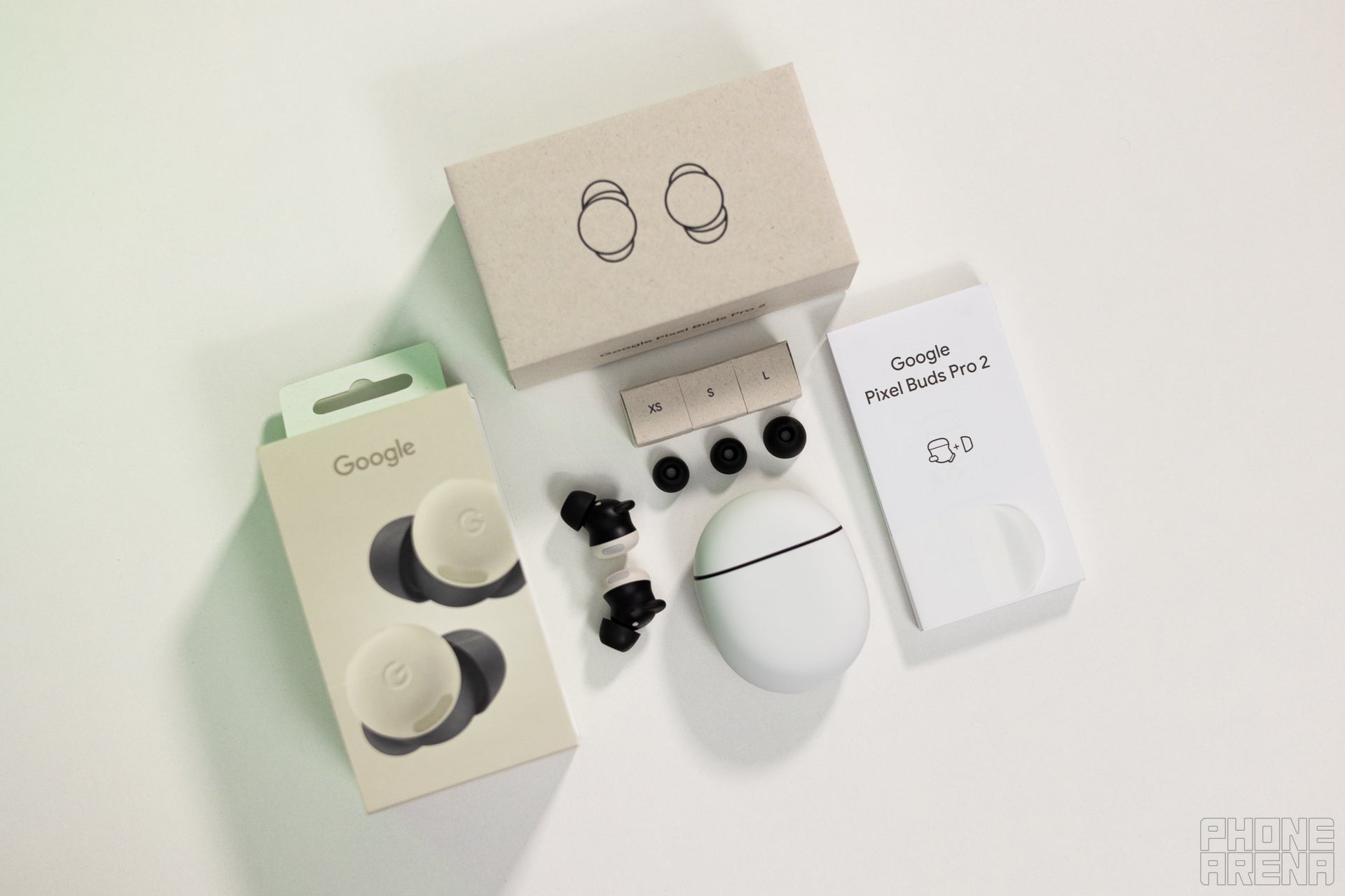 Google Pixel Buds Pro 2 surrounded by all the packaging they come with. 3 extra tip sizes, booklets, box, no cable, no charger