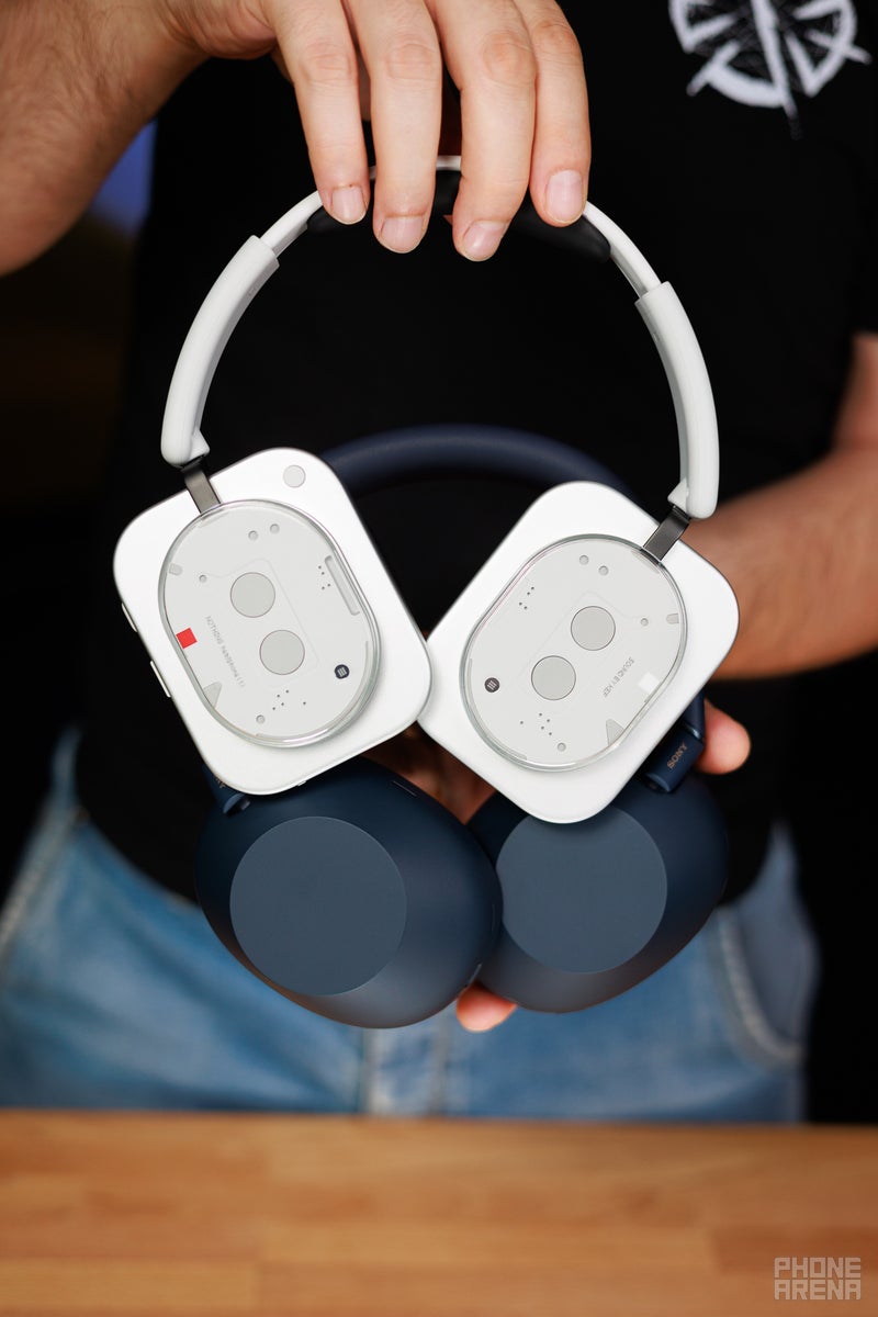 Nothing Headphone (1) and Sony WH-1000XM6 held against the camera, showing the backs of the earcups