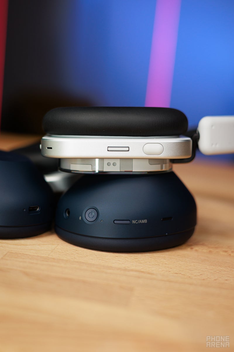 Nothing Headphone (1) and Sony WH-1000XM6 laying on their sides, showing the buttons and controls on the headphones