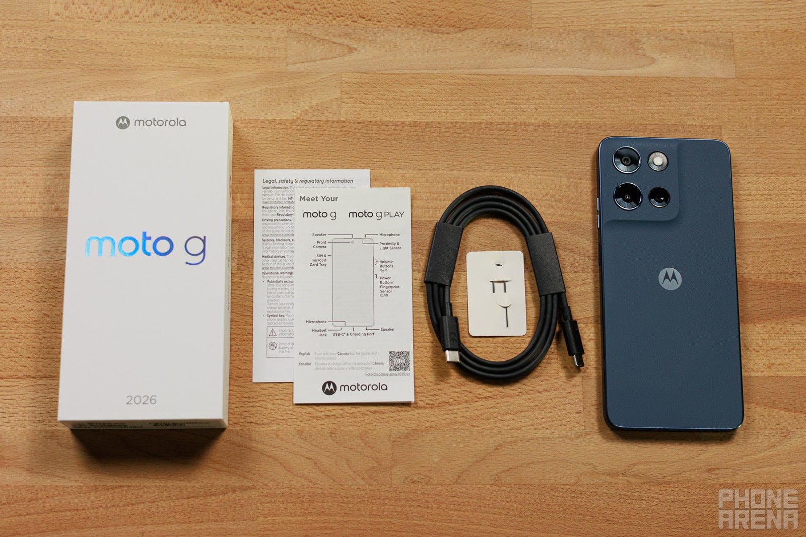 Moto G (2026) box contents laid out with phone, cable, SIM tool, and manuals
