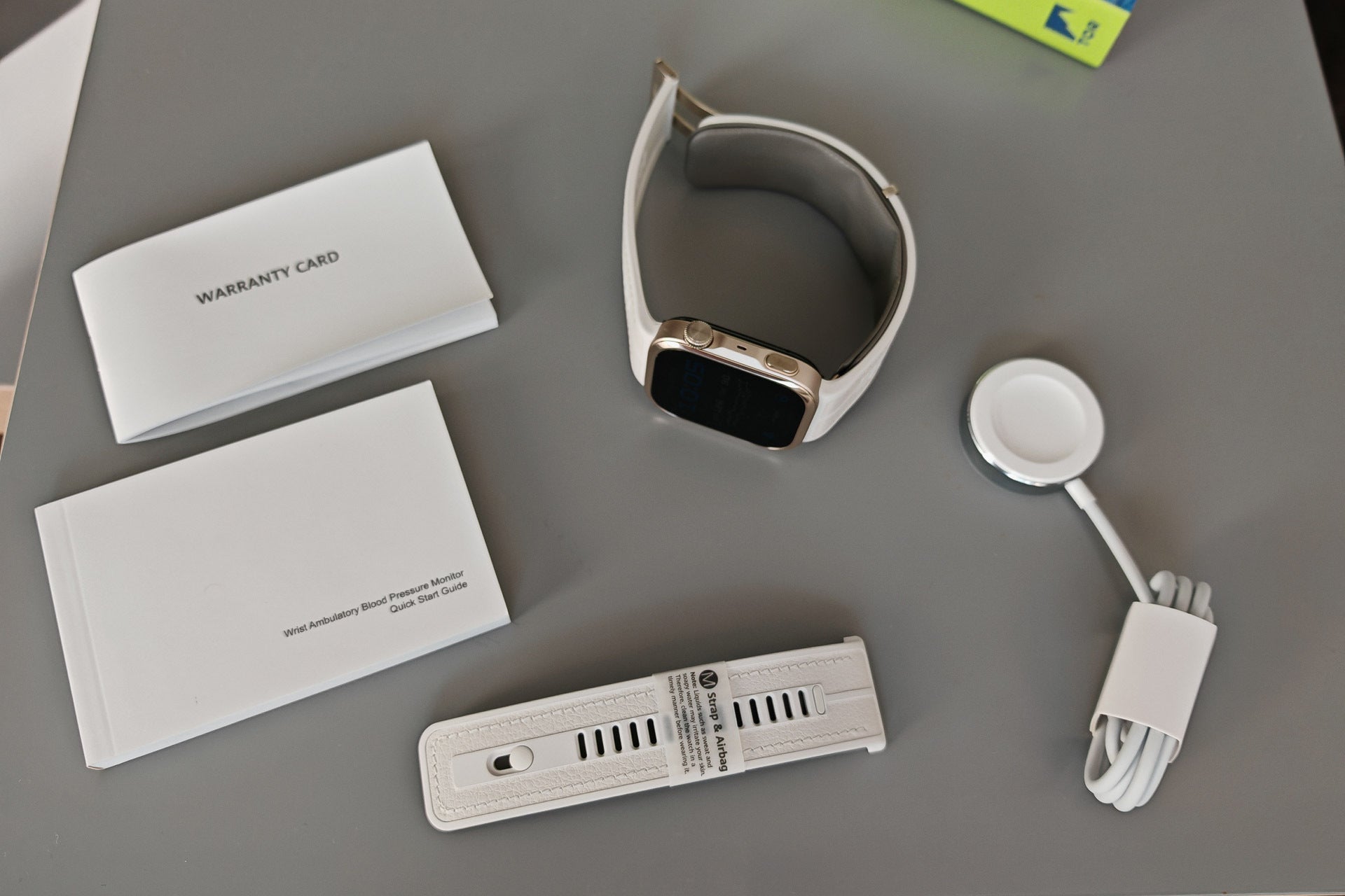 The retail box: the Watch D3 fitted with a strap and cuff (L-size), an additional strap and cuff (M-size), a wireless charging pad, and some paperwork. | Image by PhoneArena - Huawei Watch D3 review: A health revolution in action